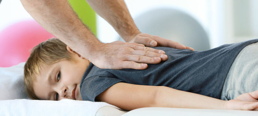 a kid receiving a back massage