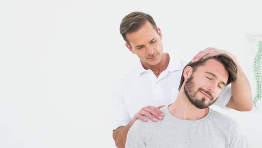 a person massaging the head of a man